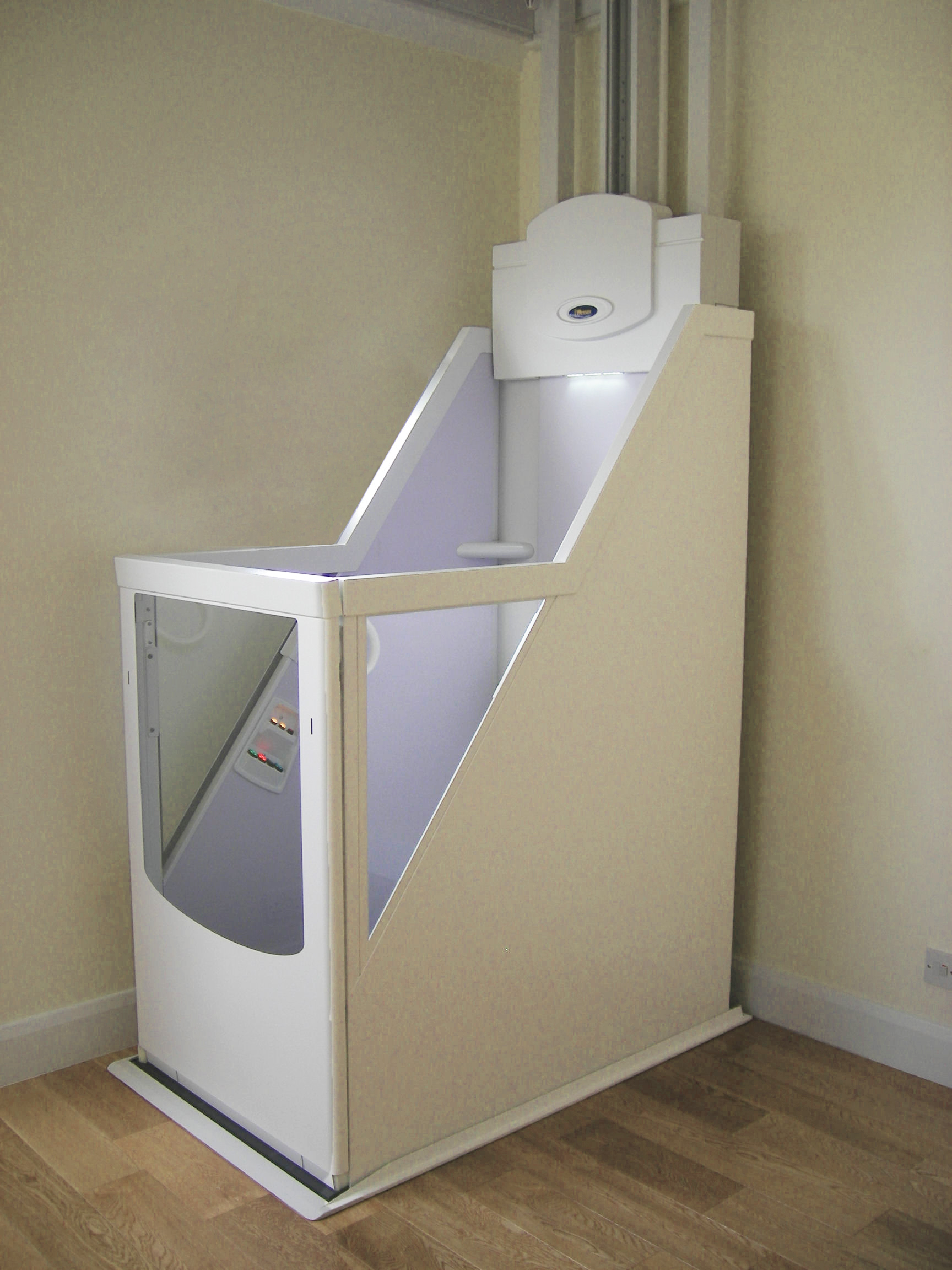 Wessex VM wheelchair through-floor lift on the ground floor with open platform and safety panels