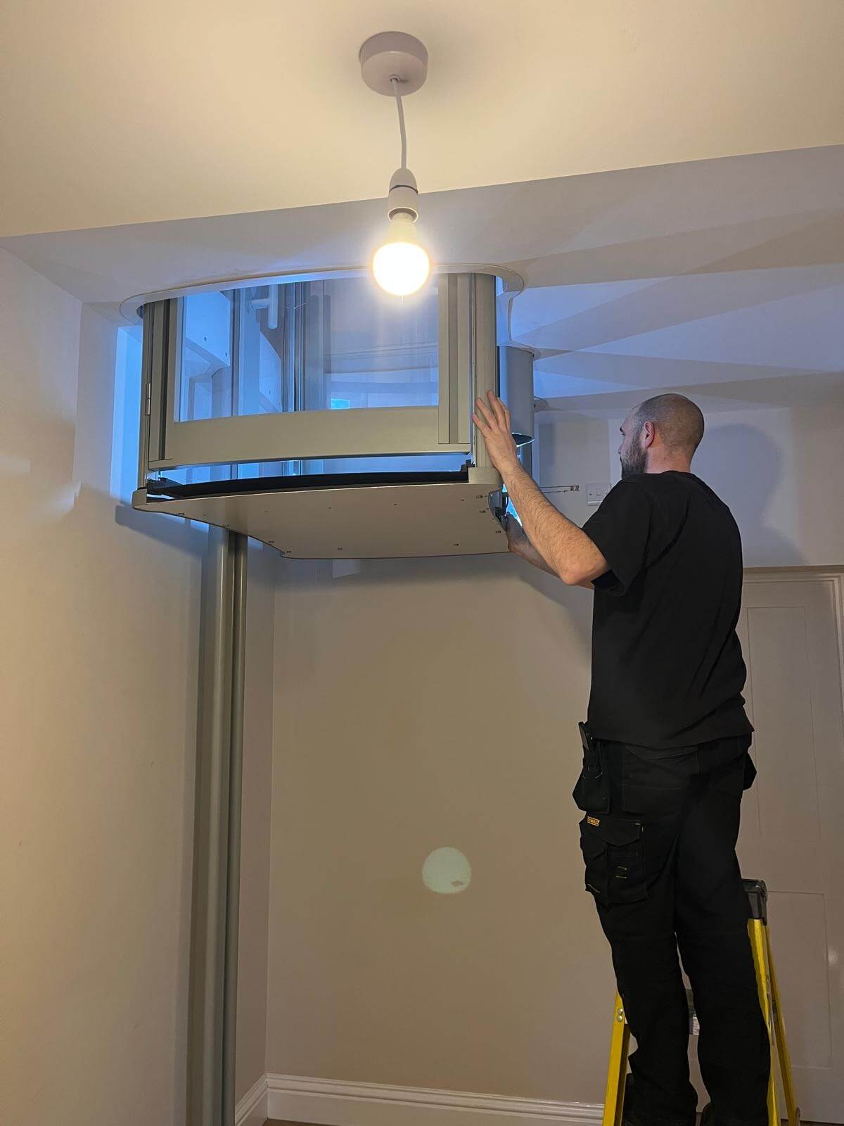 1st Choice Homelifts engineer installing a Stiltz through-floor home lift in a residential property