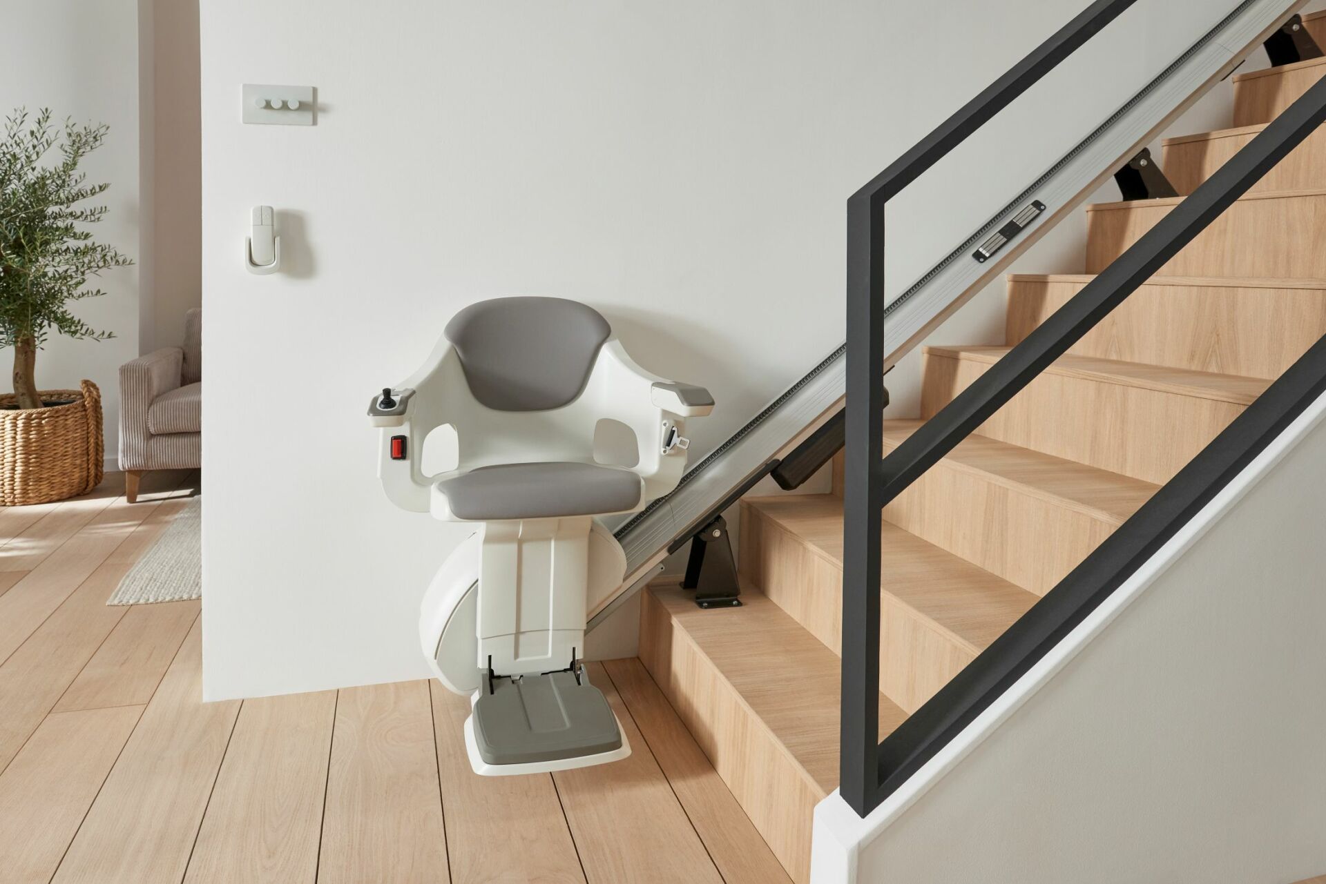 Stairlift installed at the bottom of a staircase in a modern home.